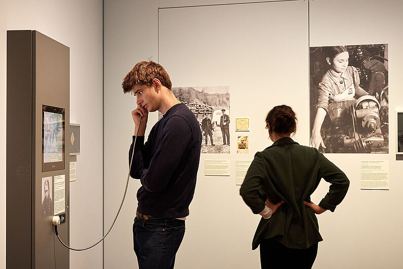 Menschen stehen in einer Ausstellung