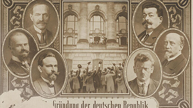 Postkarte zur Gründung der deutschen Republik mit Fotos von sechs Männern.
