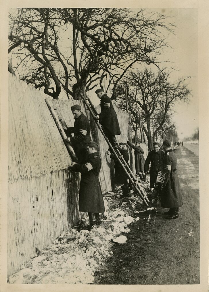 Sichtblenden werden am Westwall angebracht, Schwarz-Weiß-Abzug, 8. März 1940 Männer mit Leitern an einer Mauer