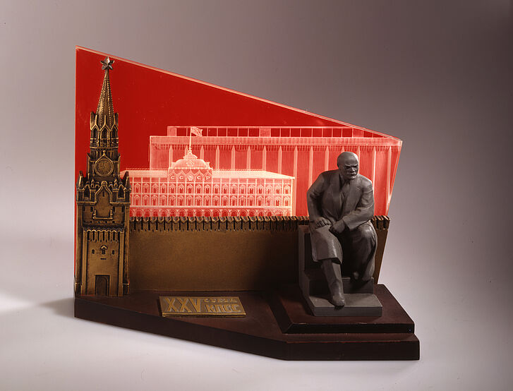 Tischmodell von Lenin, der vor einer Architektur sitzt.