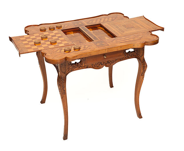 Spieltisch für Schach, Mühle und Tric-Trac, um 1750.  Ein Schach- und ein Damespiel sind in die oberen Tischplatten eingelegt. Durch seitliches Herausziehen dieser beiden Spielplatten öffnet sich auf zweiter Ebene ein Tric-Trac-Spiel, ähnlich wie Backgammon. (Inv.Nr. KG 93/64)