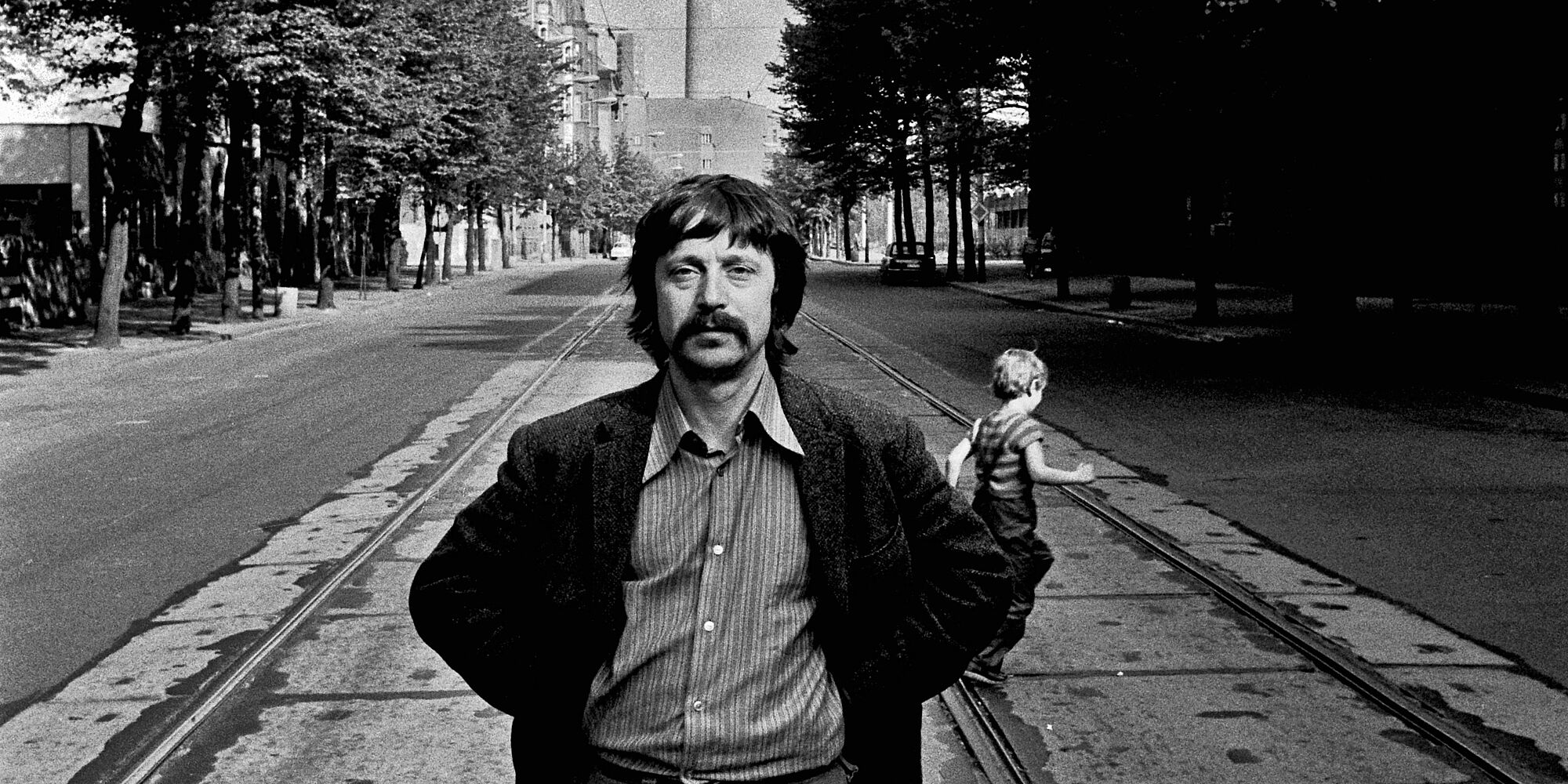 Wolf Biermann steht auf der Strasse und hinter ihm sieht man den Fernsehturm.