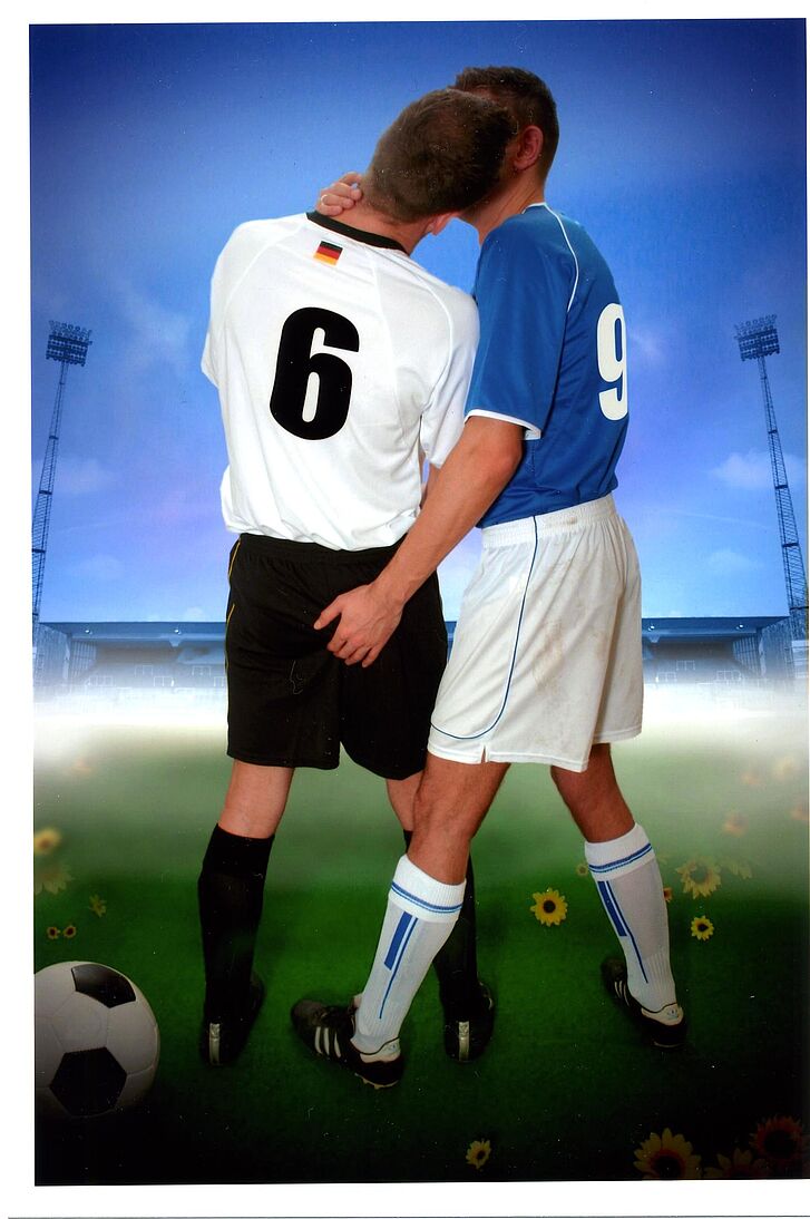 Zwei Fußballer, die sich küssen.