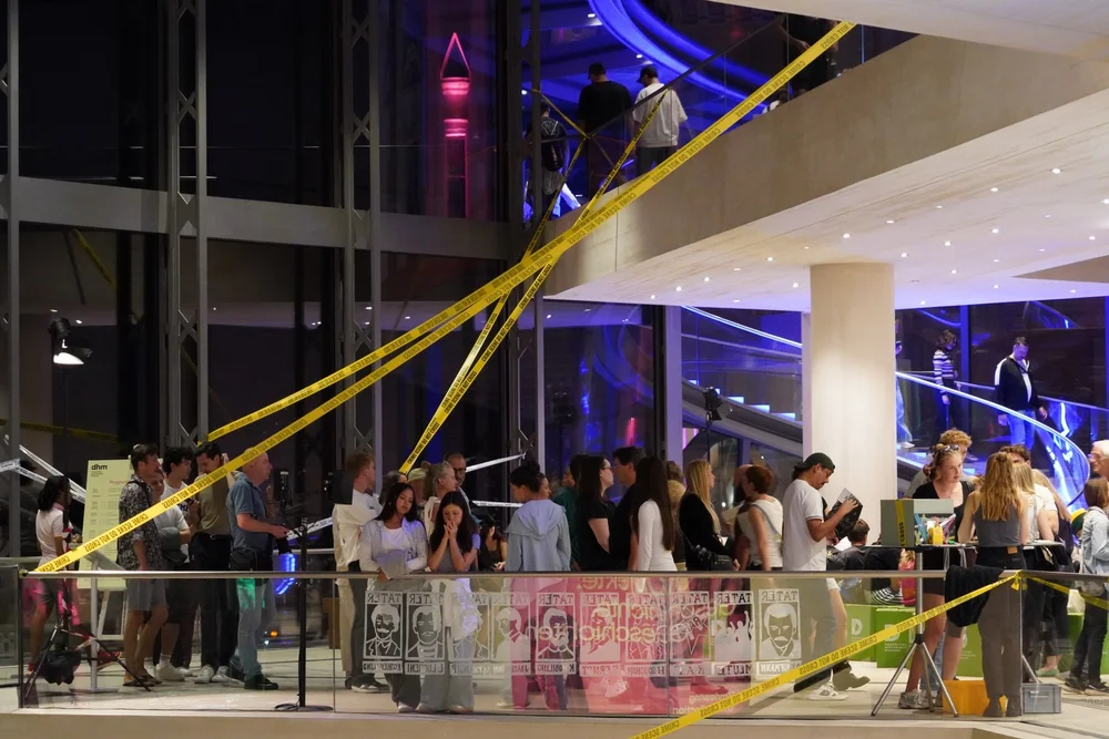 Besucher und Besucherinnen stehen im Foyer während der Langen Nacht der Museen 2026. Das Foyer ist mit Flatterbändern als "Tatort" geschmückt.