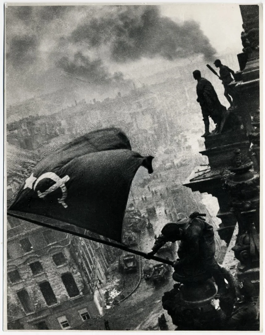 Soviet soldiers raise the Soviet flag over the Reichstag in Berlin, 2 May 1945